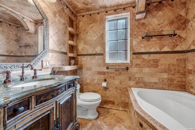 bathroom featuring vanity, a relaxing tiled tub, tile walls, and toilet