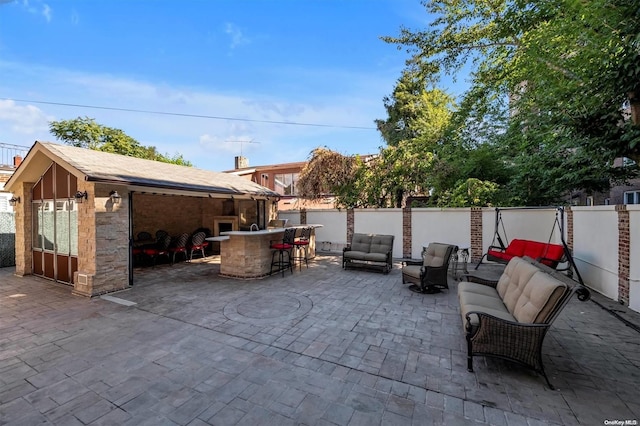 view of patio / terrace with an outdoor living space and exterior bar