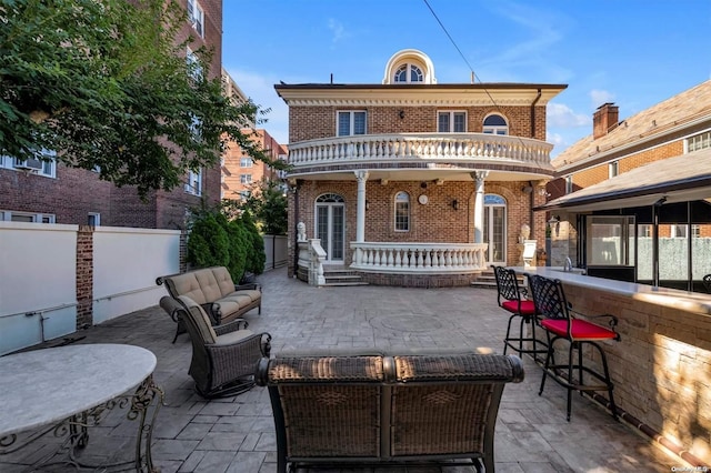 rear view of house with a bar and a patio