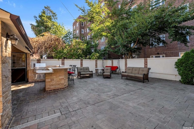 view of patio featuring an outdoor kitchen, grilling area, exterior bar, and an outdoor hangout area