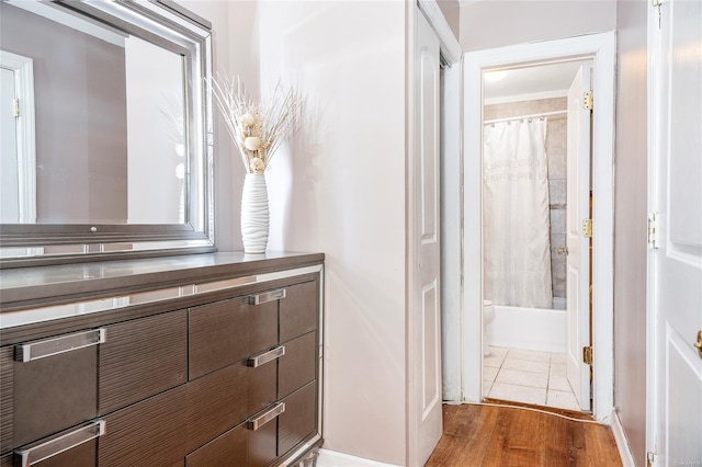 bathroom with hardwood / wood-style floors and shower / tub combo