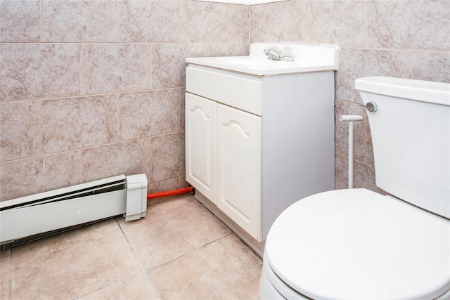 bathroom with toilet, vanity, and a baseboard radiator