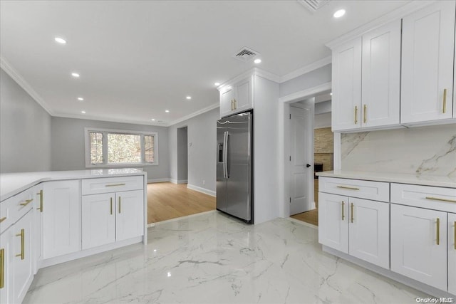 kitchen featuring stainless steel fridge with ice dispenser, crown molding, and white cabinets