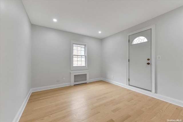 entrance foyer with light hardwood / wood-style floors and radiator