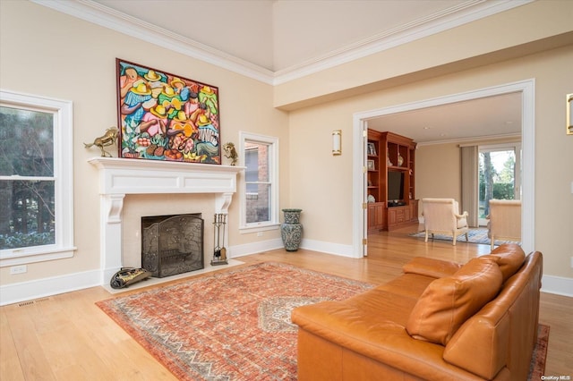 living room with hardwood / wood-style flooring and crown molding