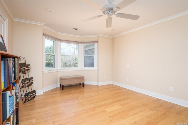 interior space with ceiling fan, light hardwood / wood-style flooring, and ornamental molding