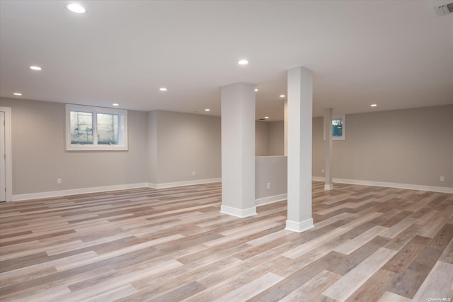 basement with light hardwood / wood-style flooring