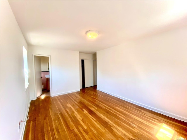 unfurnished bedroom featuring hardwood / wood-style flooring