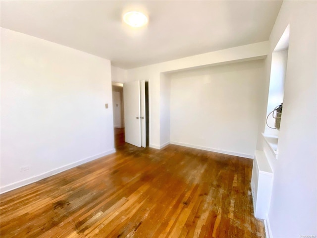 spare room with dark wood-type flooring