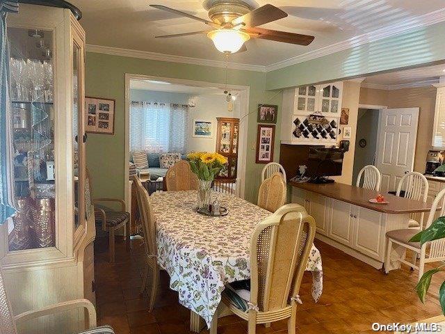 dining area featuring crown molding and ceiling fan