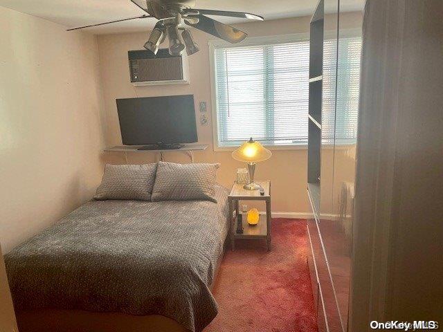 bedroom with carpet, a wall mounted AC, and ceiling fan