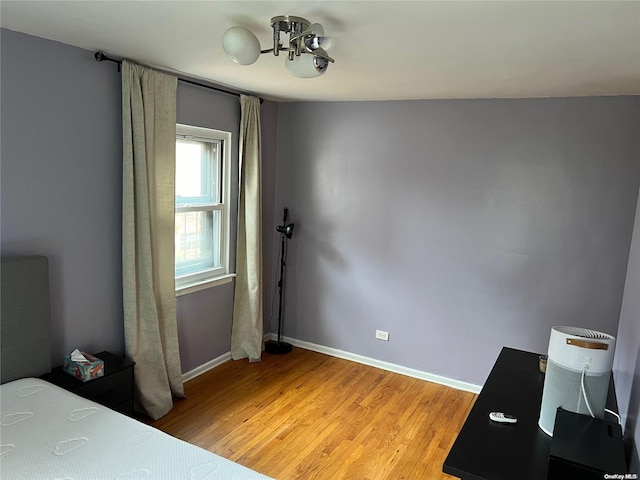 bedroom featuring light hardwood / wood-style floors and vaulted ceiling