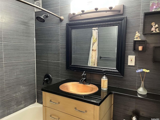 bathroom with vanity and tiled shower / bath combo