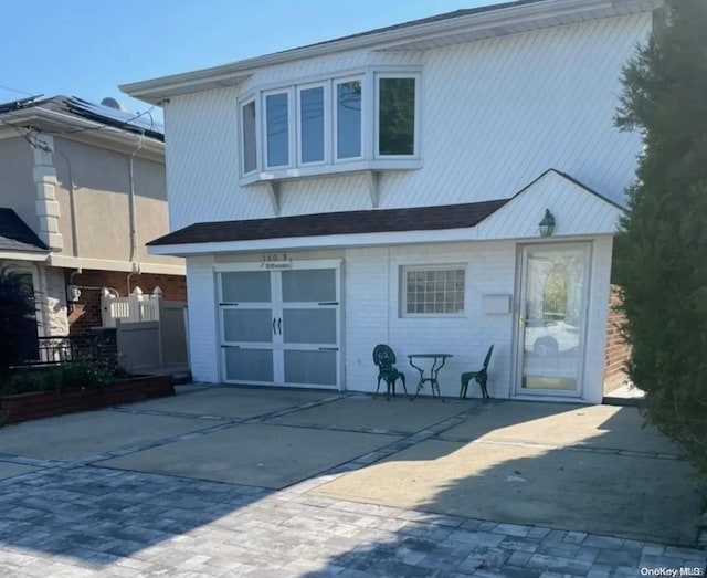 back of property featuring a garage