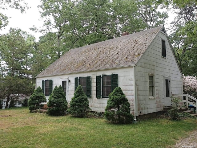 view of property exterior with a lawn