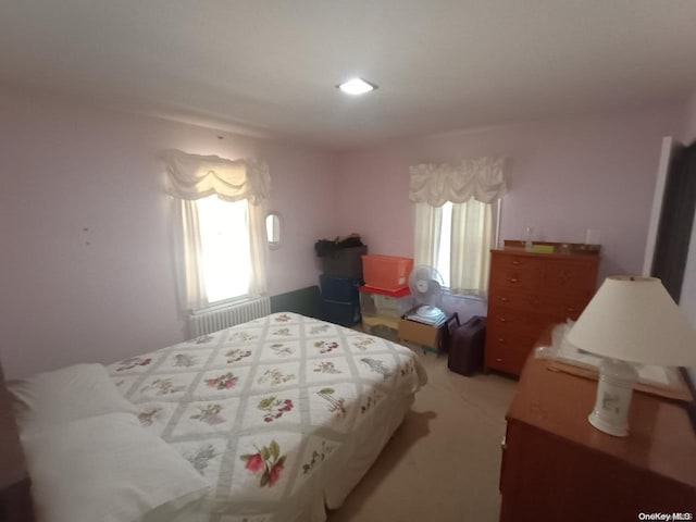 bedroom featuring radiator and carpet flooring