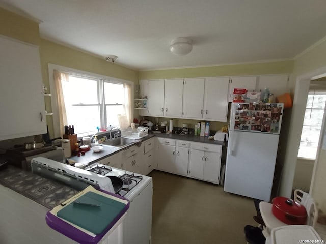 kitchen featuring white appliances, sink, and white cabinets