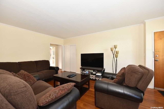 living room with hardwood / wood-style flooring and ornamental molding