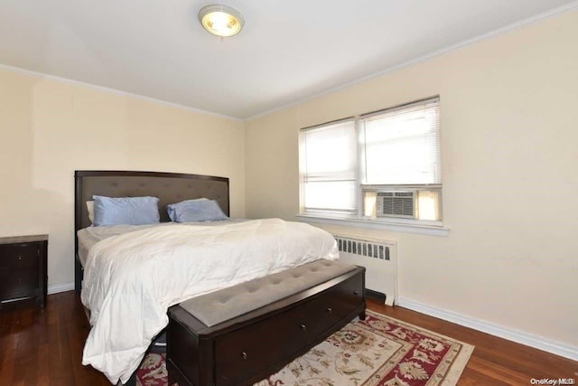 bedroom featuring crown molding, radiator heating unit, and dark wood-type flooring