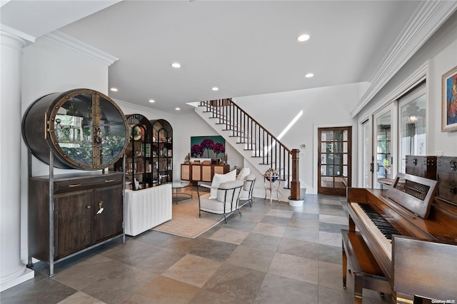 entrance foyer with decorative columns and crown molding