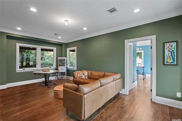 living room with crown molding and hardwood / wood-style floors