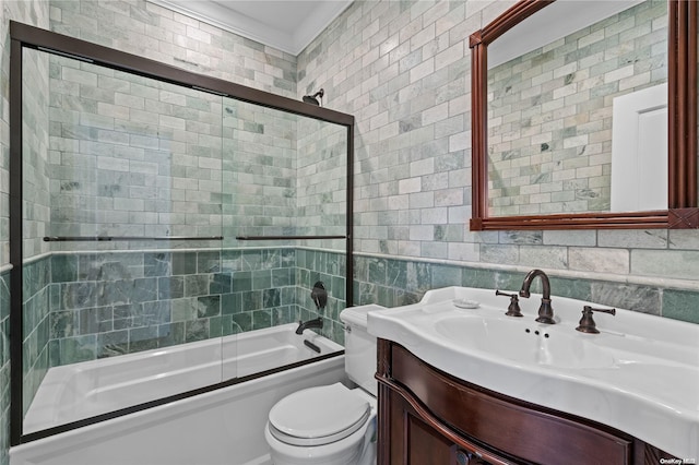 full bathroom featuring combined bath / shower with glass door, backsplash, toilet, vanity, and tile walls