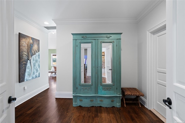 entryway with ornamental molding and dark wood-type flooring