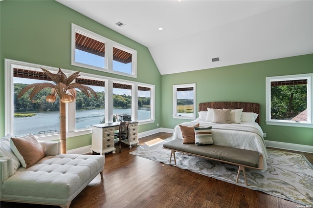 bedroom with hardwood / wood-style floors, a water view, and high vaulted ceiling