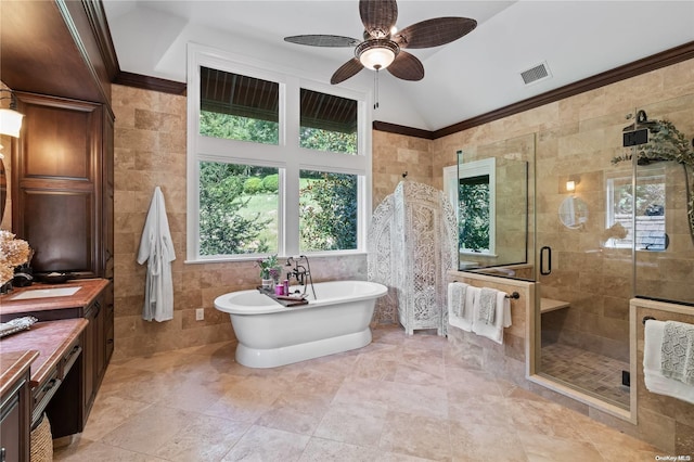 bathroom featuring vanity, lofted ceiling, ceiling fan, separate shower and tub, and tile walls