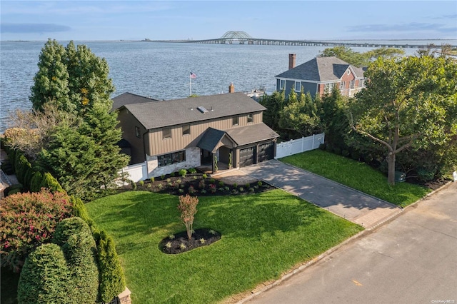 birds eye view of property with a water view