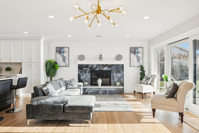 8 Shoal Dr, West Islip, NY 11795 - living room featuring light wood finished floors, a chandelier, recessed lighting, and a fireplace
