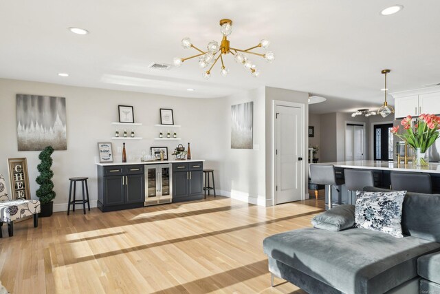 8 Shoal Dr, West Islip, NY 11795 - living area featuring wine cooler, a chandelier, bar area, recessed lighting, and light wood-style floors