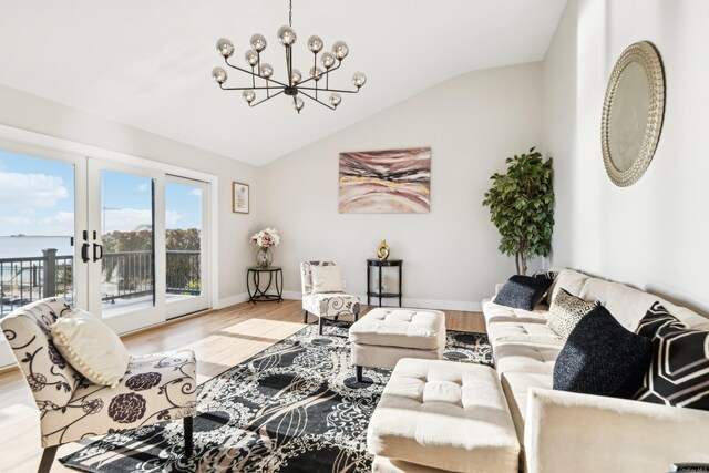 8 Shoal Dr, West Islip, NY 11795 - living room with a chandelier, vaulted ceiling, wood finished floors, and french doors