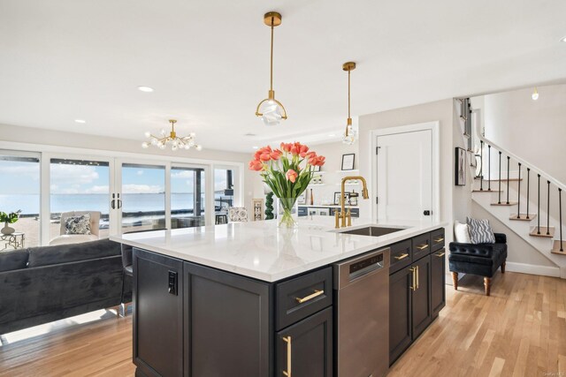 8 Shoal Dr, West Islip, NY 11795 - kitchen with dishwasher, light wood-type flooring, a center island with sink, hanging light fixtures, and a chandelier
