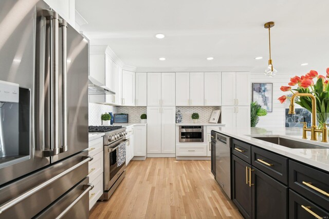 8 Shoal Dr, West Islip, NY 11795 - kitchen with appliances with stainless steel finishes, white cabinetry, hanging light fixtures, decorative backsplash, and recessed lighting
