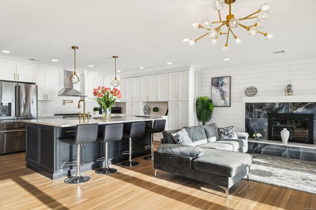8 Shoal Dr, West Islip, NY 11795 - living room with wood finished floors, a fireplace, a chandelier, and recessed lighting