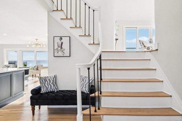 8 Shoal Dr, West Islip, NY 11795 - stairs featuring a chandelier and wood finished floors