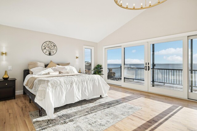 8 Shoal Dr, West Islip, NY 11795 - bedroom with multiple windows, access to outside, light wood-style flooring, high vaulted ceiling, and a water view