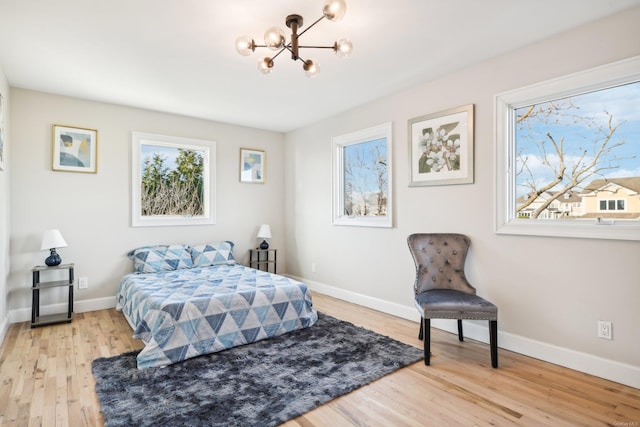 8 Shoal Dr, West Islip, NY 11795 - bedroom featuring a chandelier and light wood-type flooring