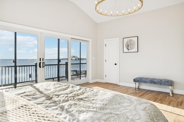 8 Shoal Dr, West Islip, NY 11795 - bedroom with a chandelier, a water view, access to exterior, wood finished floors, and high vaulted ceiling