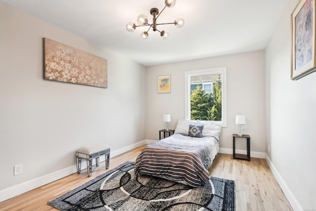 8 Shoal Dr, West Islip, NY 11795 - bedroom featuring a chandelier and light wood finished floors