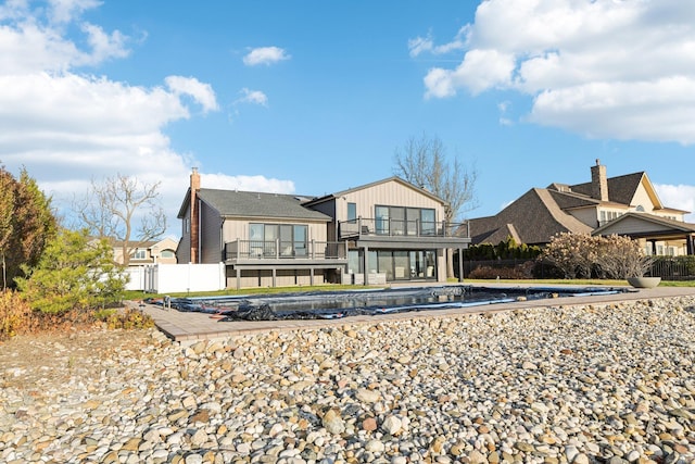 8 Shoal Dr, West Islip, NY 11795 - rear view of property featuring a balcony and a chimney