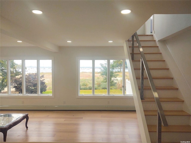 interior space with baseboard heating and light hardwood / wood-style floors