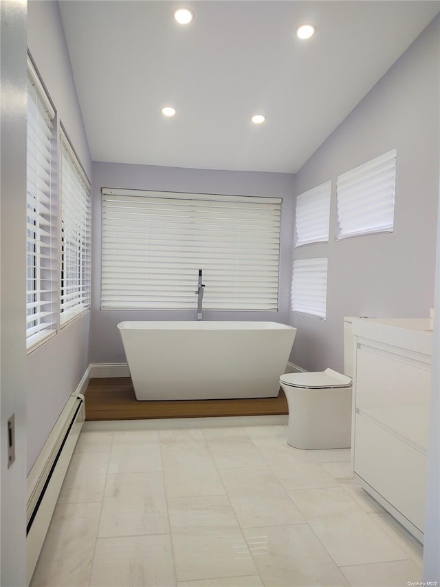 bathroom with a baseboard heating unit, a bath, lofted ceiling, and tile patterned flooring