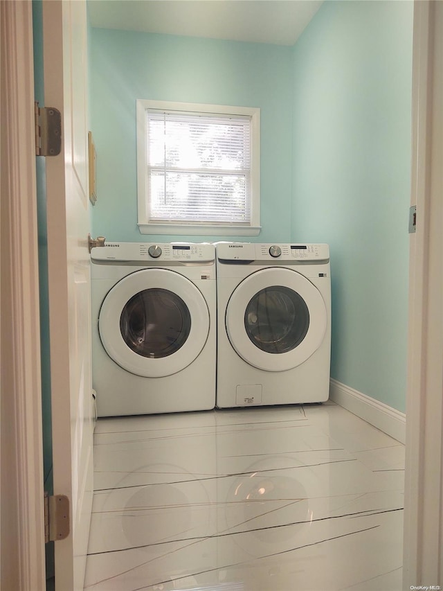 clothes washing area with separate washer and dryer