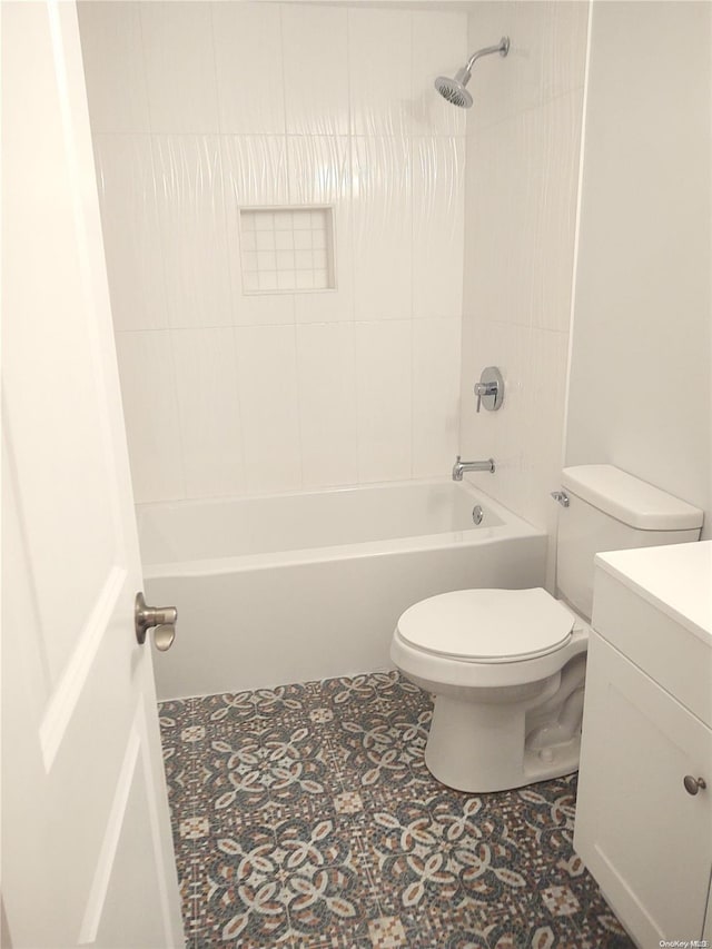 full bathroom featuring toilet, vanity, and tiled shower / bath