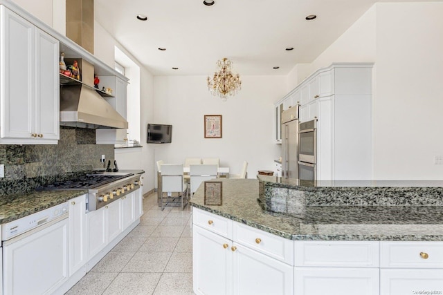 kitchen featuring white cabinets, stainless steel appliances, and dark stone counters