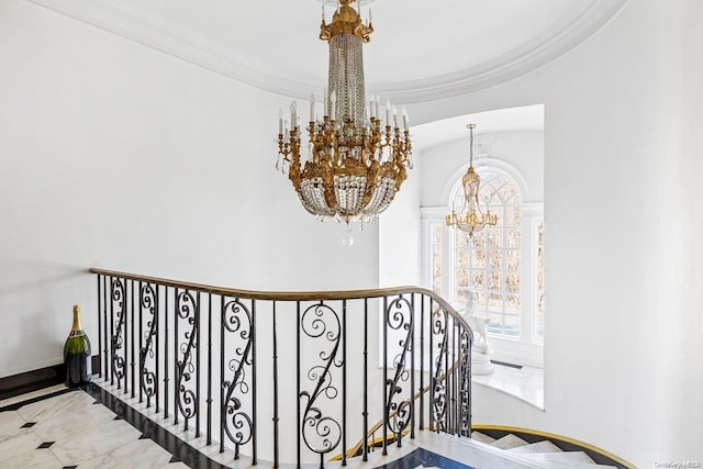 staircase with crown molding and an inviting chandelier