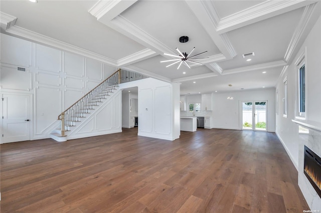 unfurnished living room featuring beam ceiling, dark hardwood / wood-style flooring, ornamental molding, and coffered ceiling