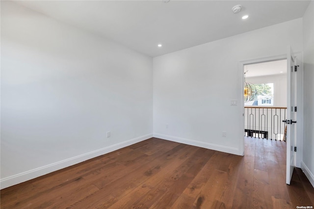 spare room featuring dark wood-type flooring